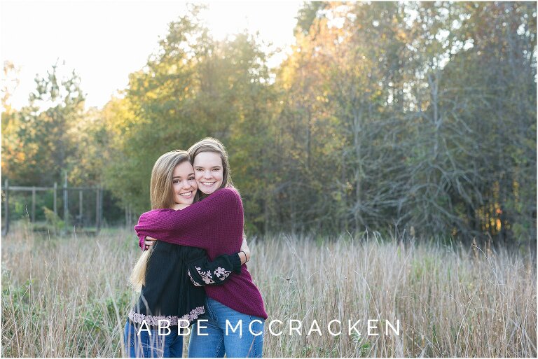 Teenage sisters hugging in a wheat field south of Charlotte, NC