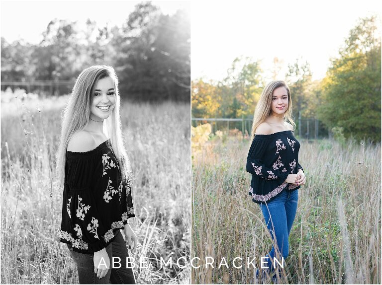 Gorgeous senior girl in jeans and black off the the shoulder top standing in a wheat field, backlighting