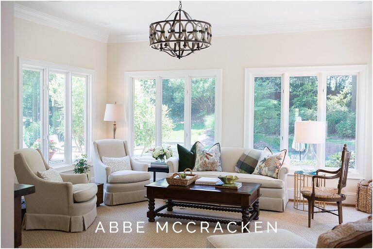 Warm and cozy sunroom in Quail Hollow home. Interior design by The Warrick Company.