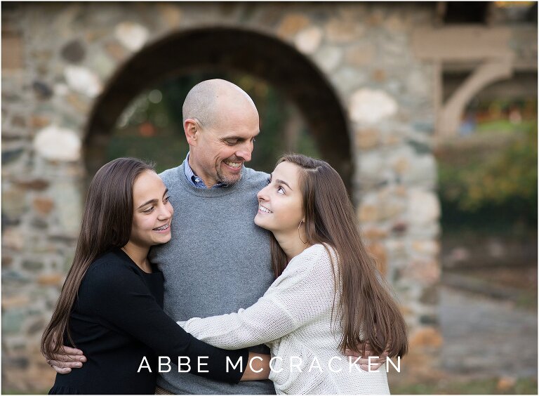 fall family photo of teenage daughters with their dad