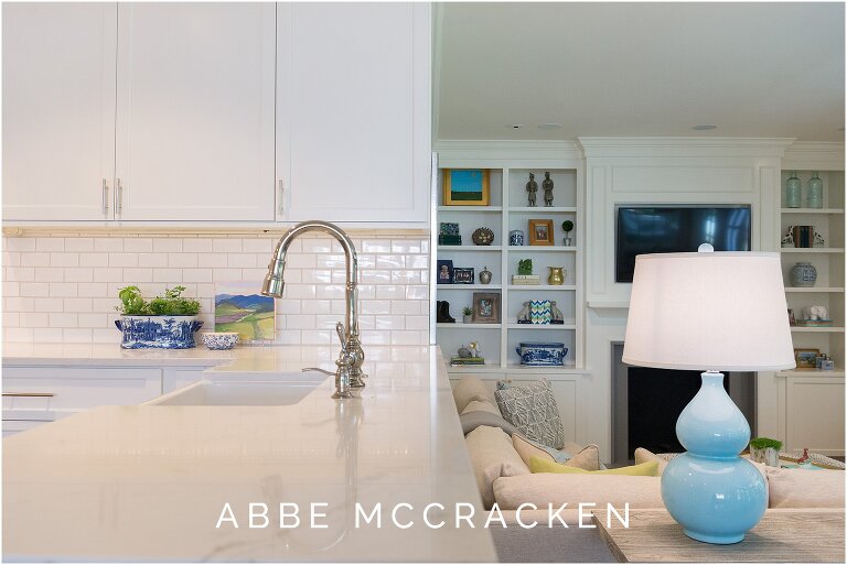 Split view of kitchen details and family room, showcasing level change