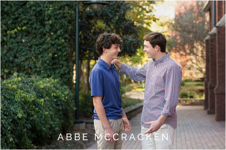 candid picture of teenage boy siblings teasing each other, photographed during a high school senior session