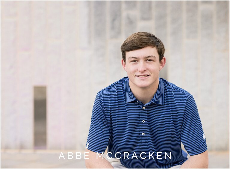 Graduating senior boy in striped blue shirt