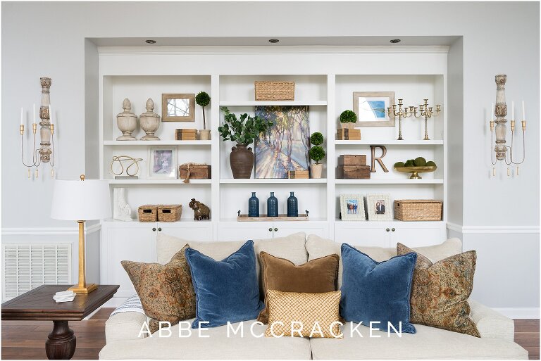 Gorgeously decorated open bookcases in a Huntersville, NC family room