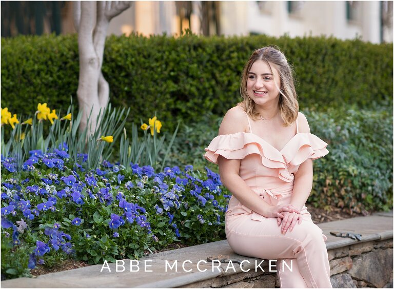 Teenage girl sitting near spring flowers on The Green