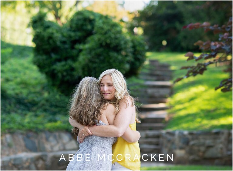 Mother holding her high school graduate tight