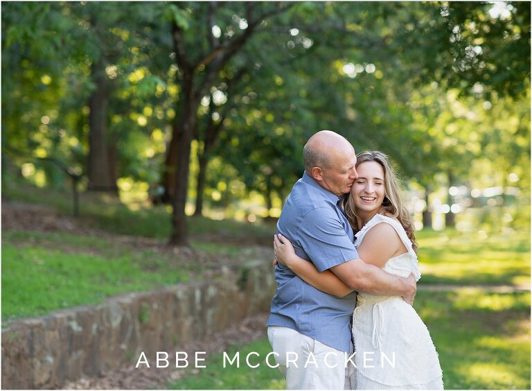 High school senior and her father hugging during senior photo session