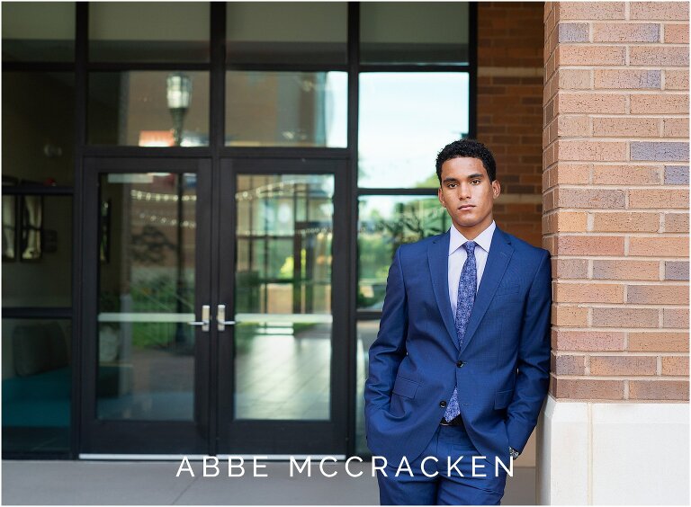 Senior guy in blue suit and tie on campus at Providence Day School