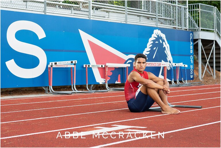 PDS Senior and hurdle star sitting in uniform on the track