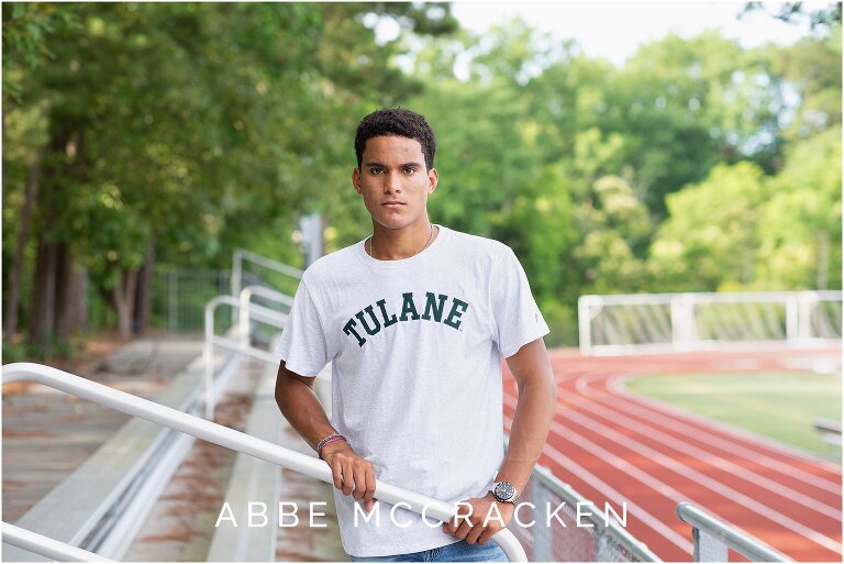 Senior portrait with the track at Providence Day School in the background