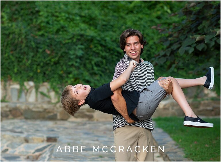 Senior boy and his younger brother goofing around during senior portrait session