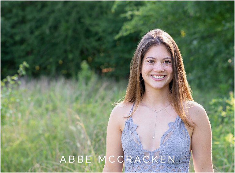 Senior portrait of a gorgeous brunette with freckles