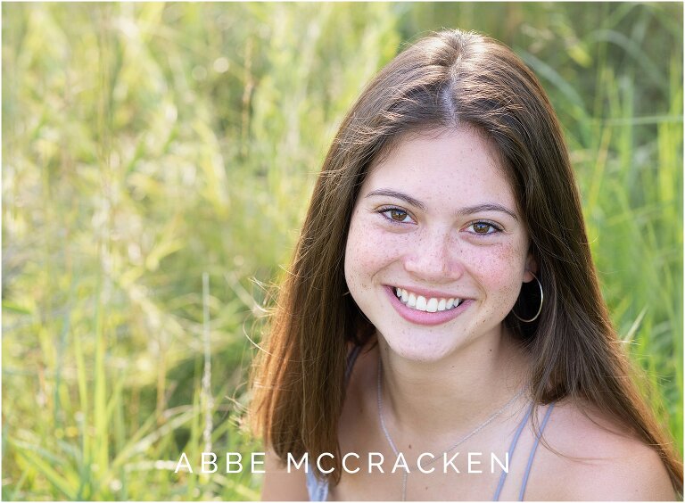 Senior portrait of recent graduate with freckles