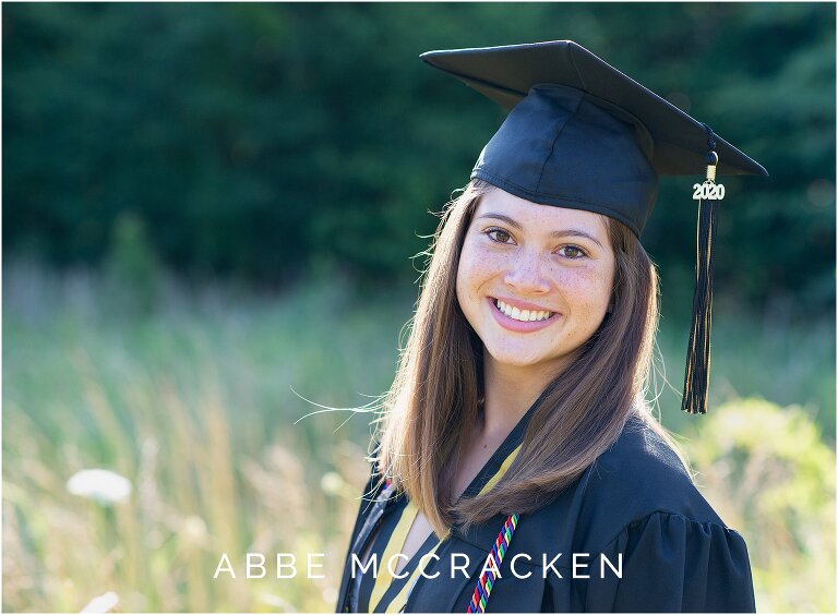 Backlit Senior portrait of 2020 graduate in cap and gown