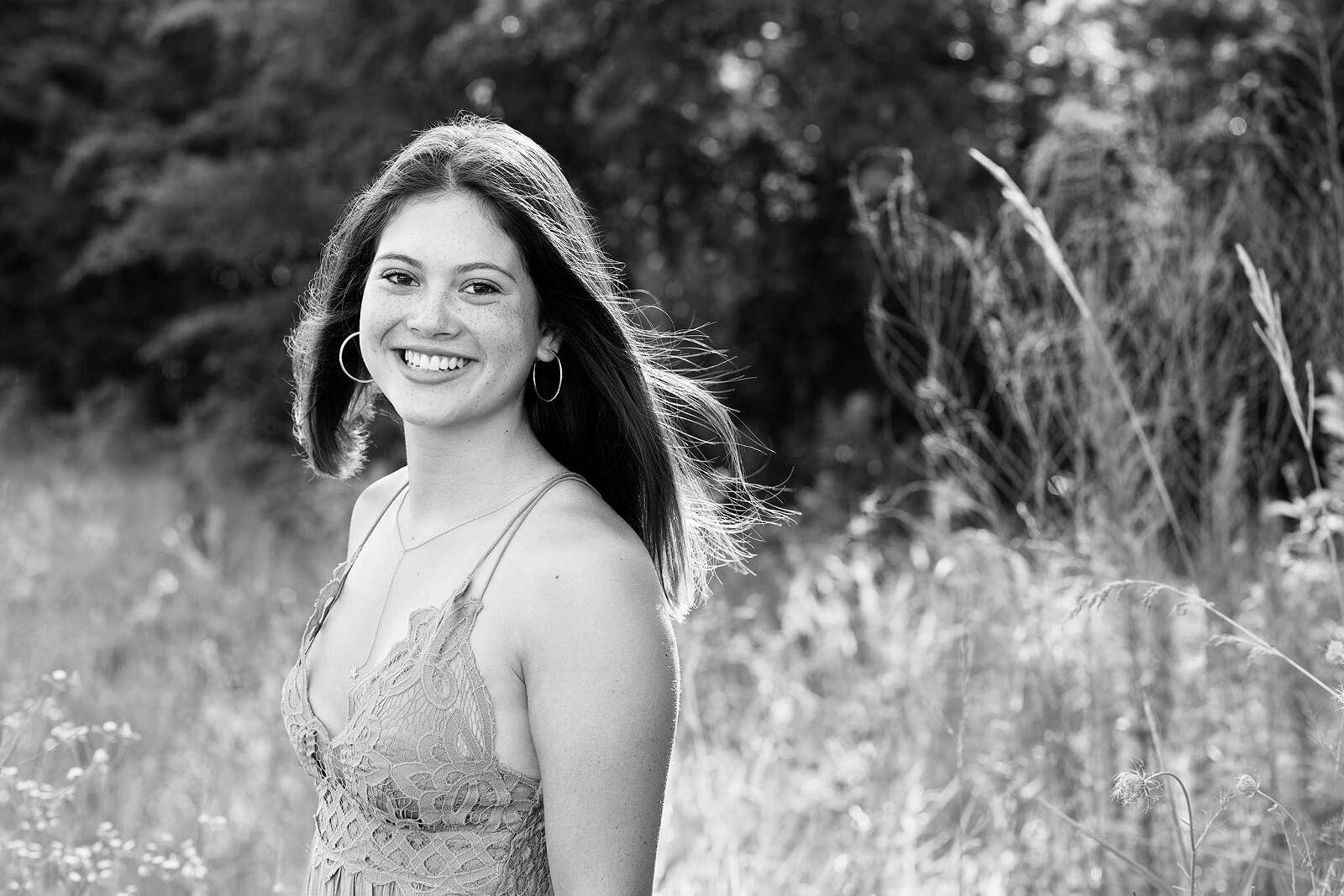 Black and white portrait of a senior girl in Marvin, NC wheat fields