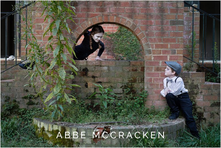 Professional Halloween picture of ghost children playing among the ruins and weeds of an abandoned home
