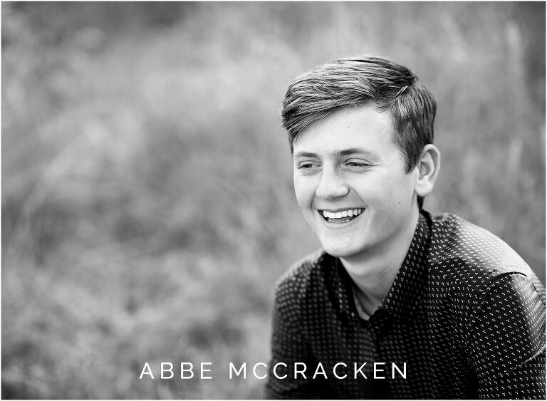 candid black and white image of teen boy in button up shirt