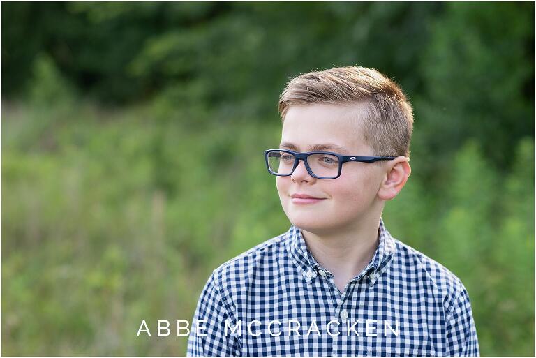 candid portrait of a boy in glasses