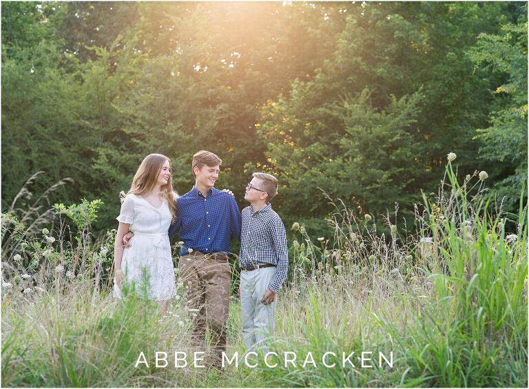 Siblings being touched by the summer sun in the wheat fields of Marvin Efird Park