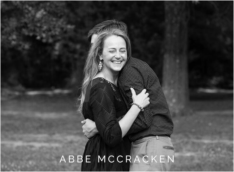 Black and white image of mother hugging her teenage son