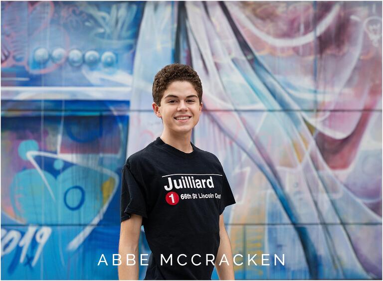 Senior portrait of a dancer with colorful mural in background, Charlotte NC