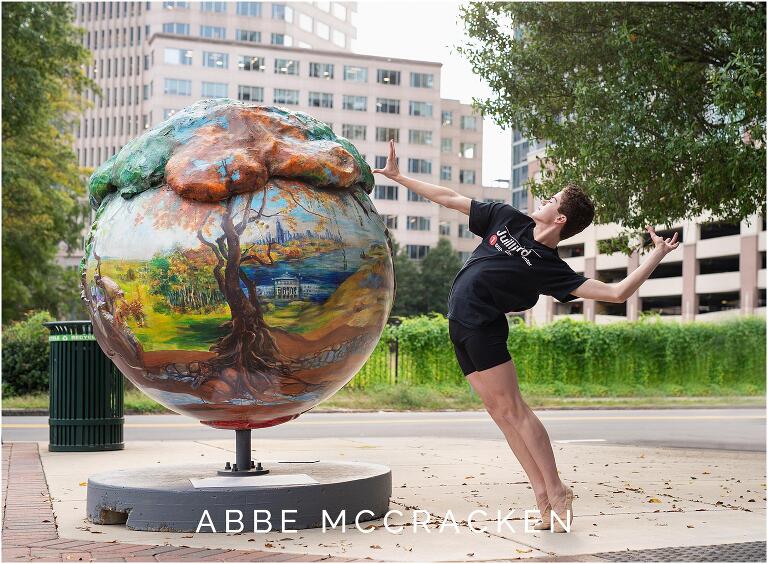 Portrait of a high school senior dance student outside of Charlotte Ballet posing with street art