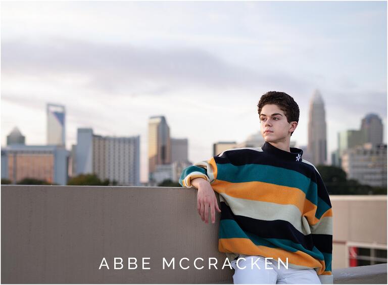 Senior portrait with Charlotte skyline in background