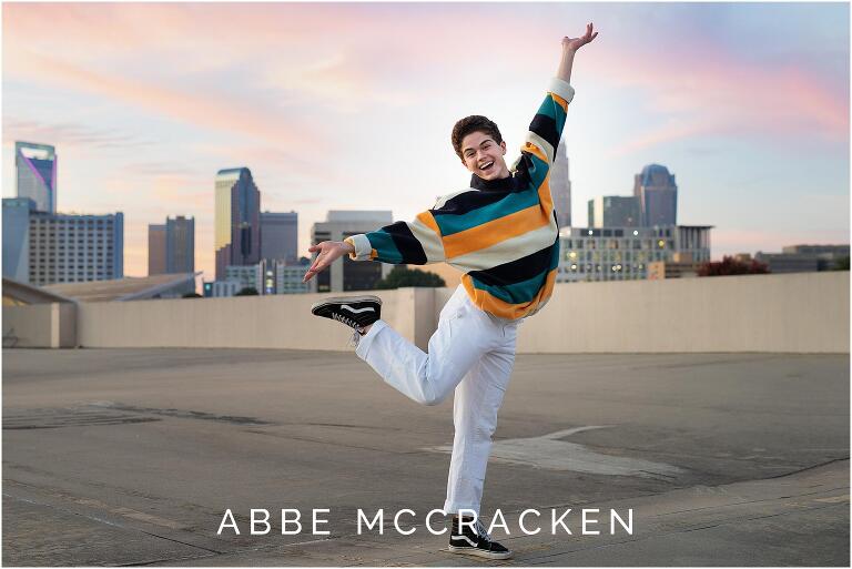 Senior portrait of a dancer with Charlotte skyline in background