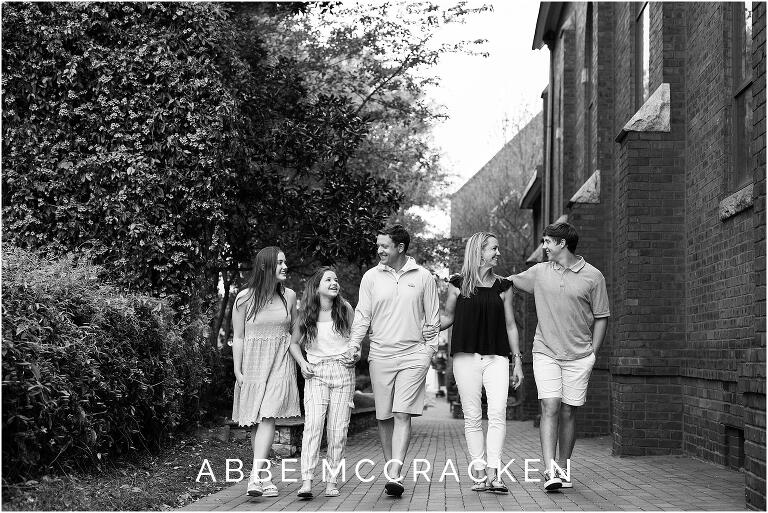 black and white photography of a family walking in Uptown Charlotte