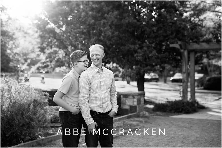 Black and white candid picture of father and son laughing