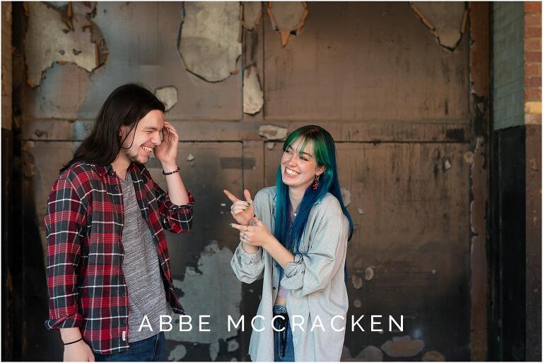 Siblings laughing at each other in warehouse area of Camp North End, Charlotte