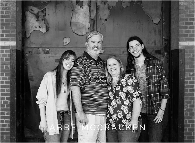 Black and white family portrait in urban warehouse setting