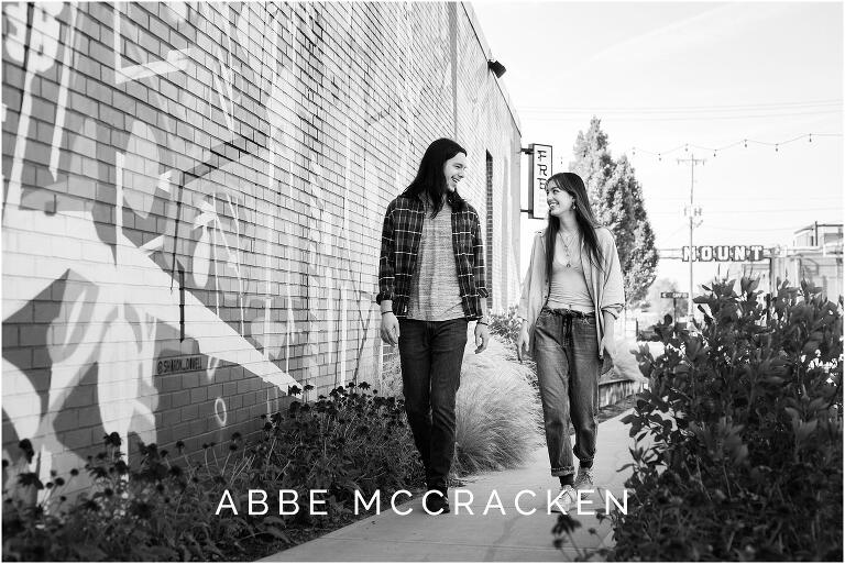 Black and white picture of teenage siblings walking together in Camp North End