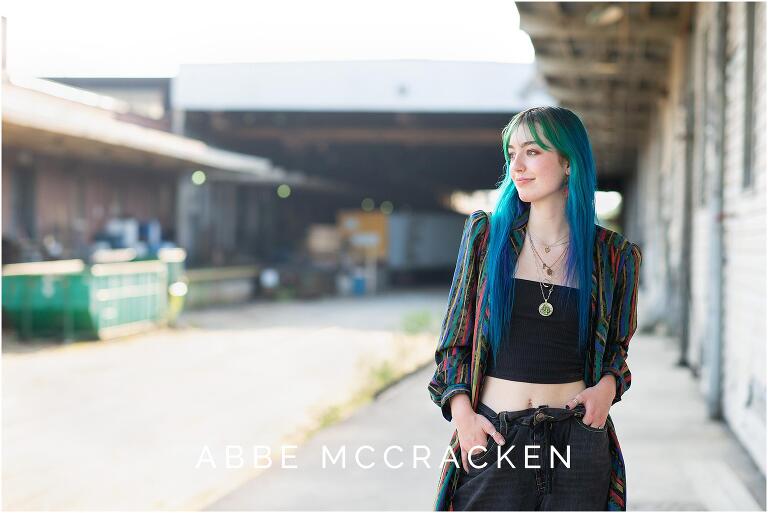 Urban senior portrait in warehouse loading dock area of Camp North End