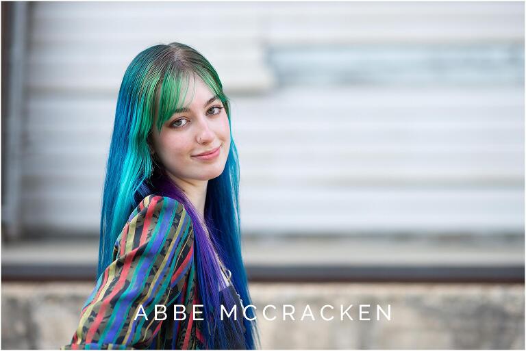 Close up of a high school senior girl with green, blue and purple hair