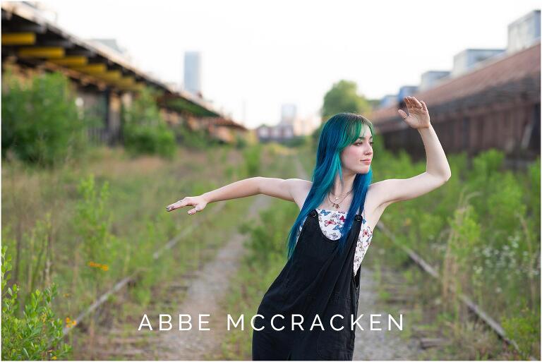 Senior portrait of a dancer posing on abandoned railroad tracks