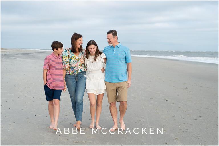 Family walking on the beach and laughing