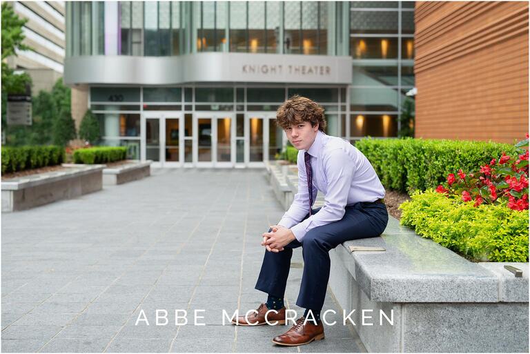 Formal portrait of a high school senior in front of the Knight Theater in Uptown Charlotte