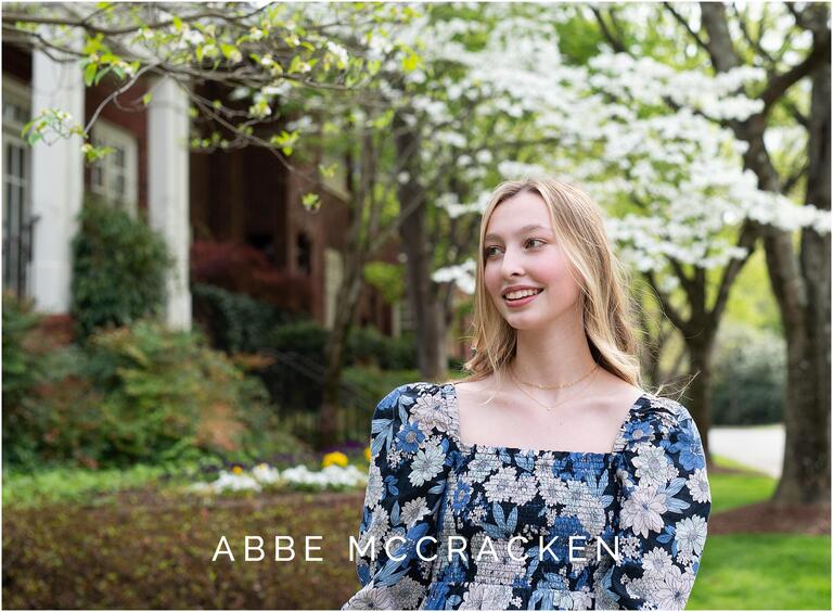 senior portraits in Myers Park with dogwoods blooming in background