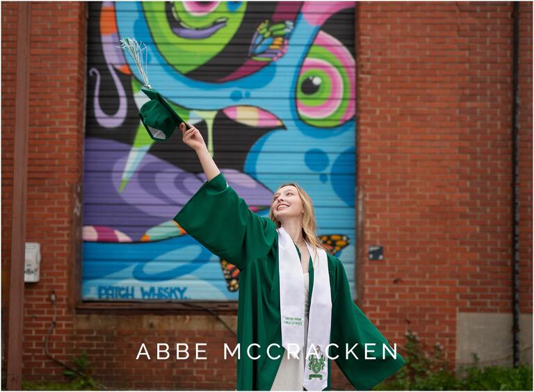 Myers Park senior in green cap and gown