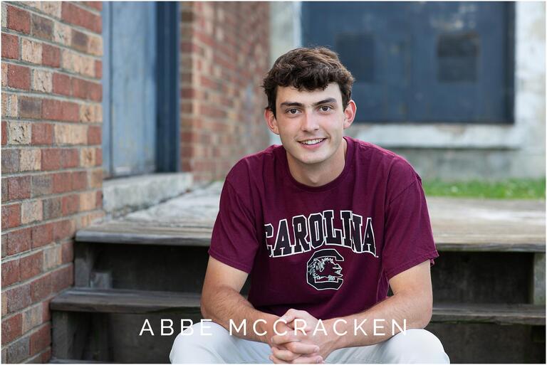Senior guy wearing his collegiate shirt