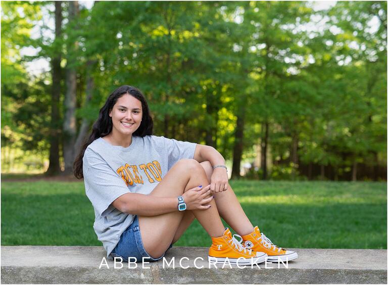 Senior portrait wearing college gear, orange Converse