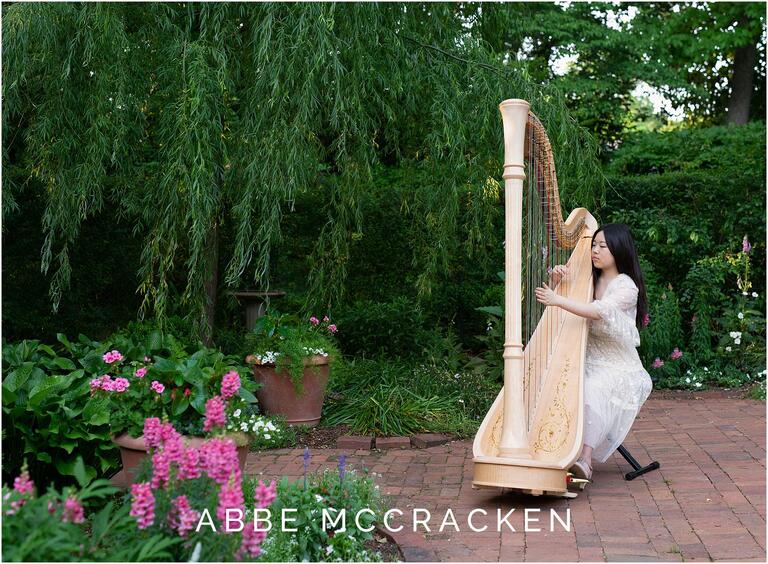 Senior portraits of girl playing harp in Winghaven Gardens