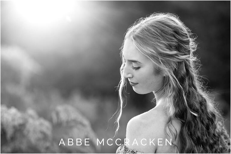 Gorgeous black and white backlit senior portrait with sunflare