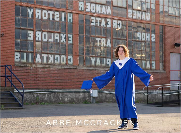 Senior guy wearing blue cap and gown at Camp North End