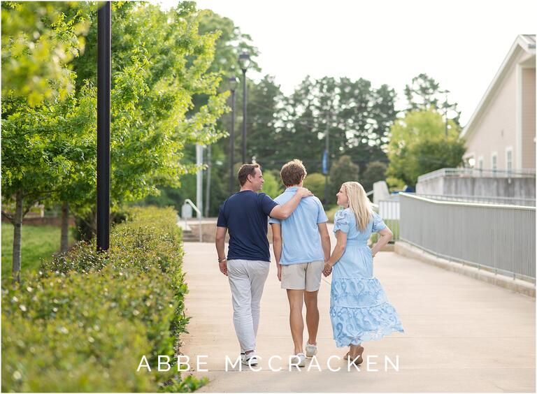 Parents walking with high school senior son on the campus of Charlotte Christian School