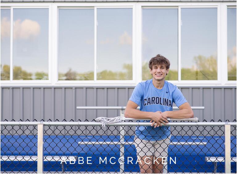 Portrait of a senior scholar athlete in the stands of Guy Field at Charlotte Christian School