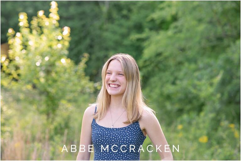 Candid spring portrait of high school senior laughing