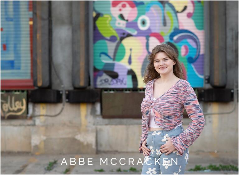 Senior portrait in front of loading dock murals in Camp North End, Charlotte NC