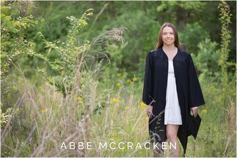 High school senior in Charlotte, NC photographed wearing graduation gown